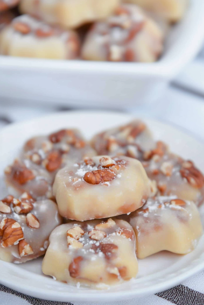 Sugary confections with whole pecans visible in each piece.