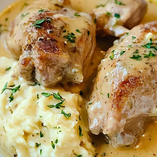 Hearty Rabbit in Mustard Sauce Recipe plated with buttery mashed potatoes and sprinkled thyme.