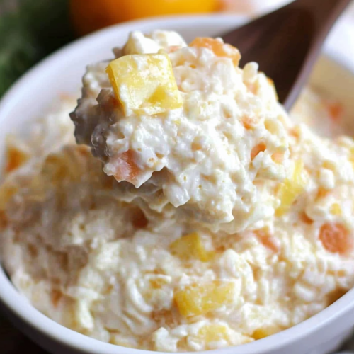 Creamy rice dish with chunks of pineapple served in a bowl