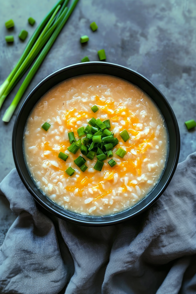 Warm and comforting bowl of savory rice porridge garnished with spring onions.