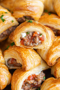 Golden puff pastry rolls filled with savory meat and cheese.