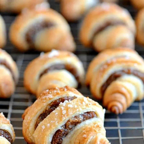Close-up of buttery rolled pastries with caramelized cinnamon filling.