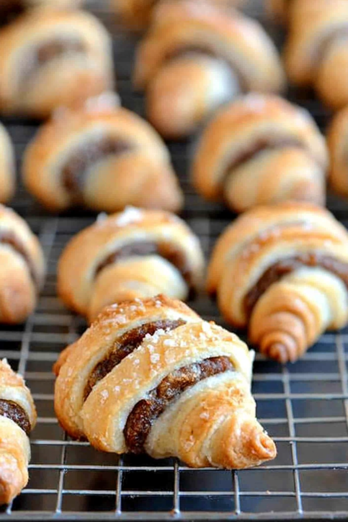 Close-up of buttery rolled pastries with caramelized cinnamon filling.