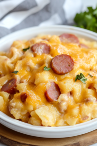 Final serving of cheesy casserole, garnished with fresh herbs for color.