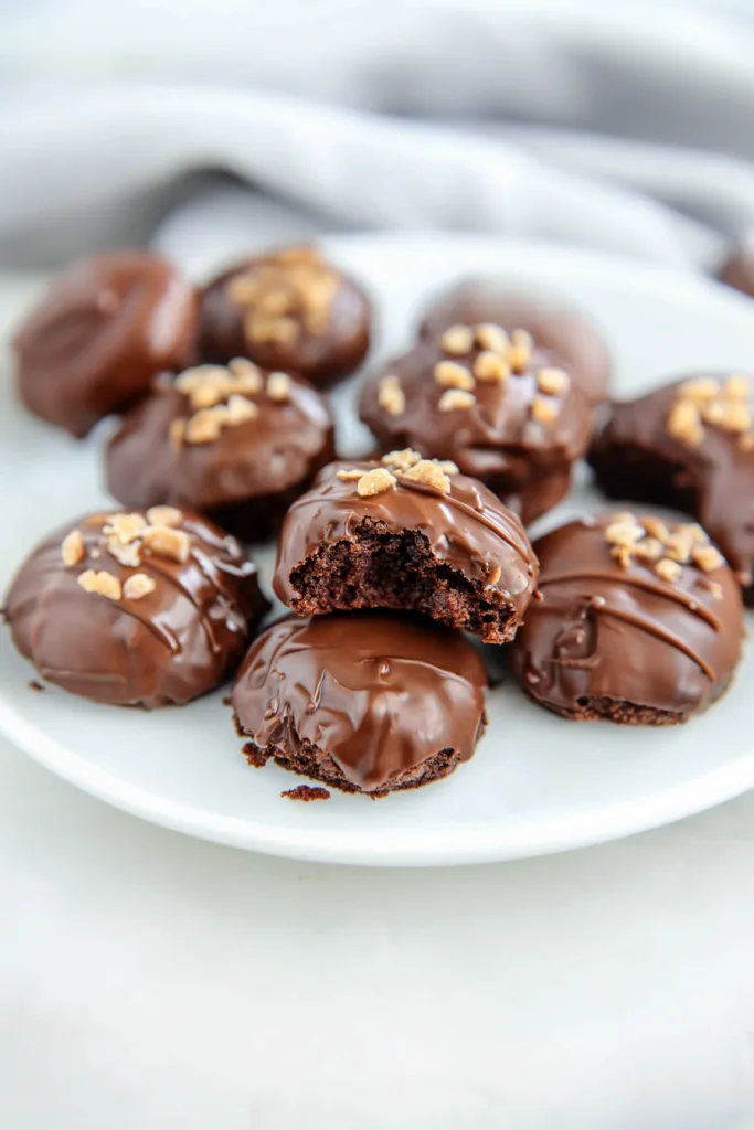 Homemade chocolate cookies coated in smooth icing with a slightly crisp edge