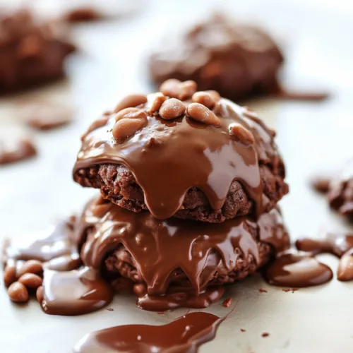 Soft chocolate cookies topped with glossy fudge icing and chopped nuts