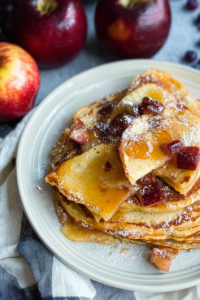 Thick oven-baked pancake served with warm apples and a drizzle of syrup