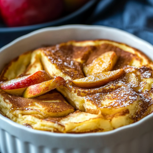 Rustic breakfast dish with soft pancake layers and sweet cooked apples on top