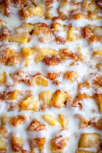 Close-up of apple-studded breakfast casserole showing crisp crust and glossy glaze