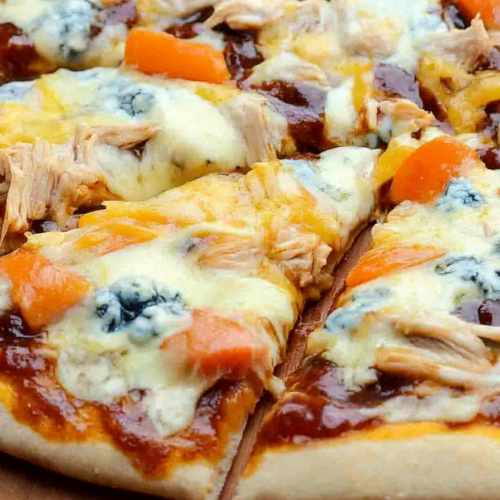 Close-up of sliced pizza highlighting gooey cheese, savory toppings, and crisp edges.