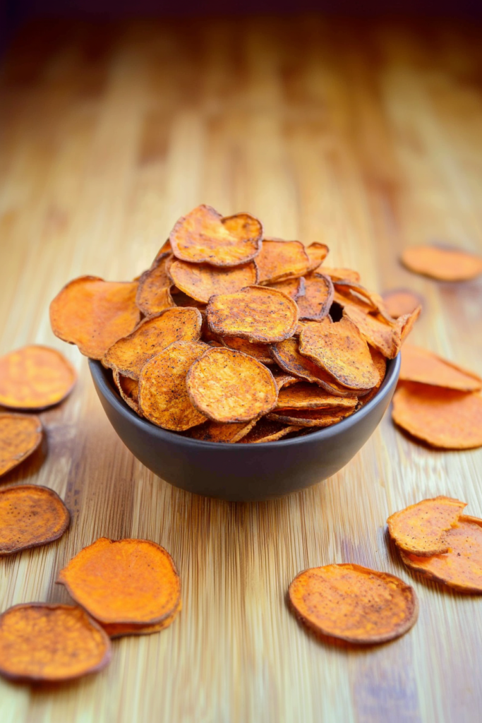 Stack of thin, round chips glowing under warm light, emphasizing their airy crunch.