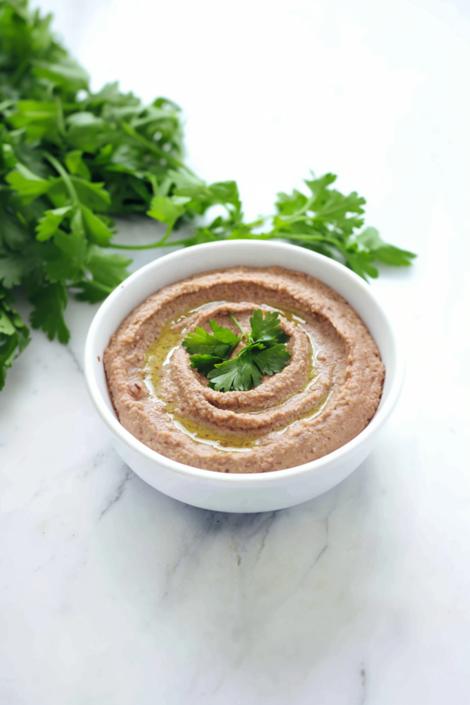 Homemade hummus-style dip made from black beans, topped with olive oil