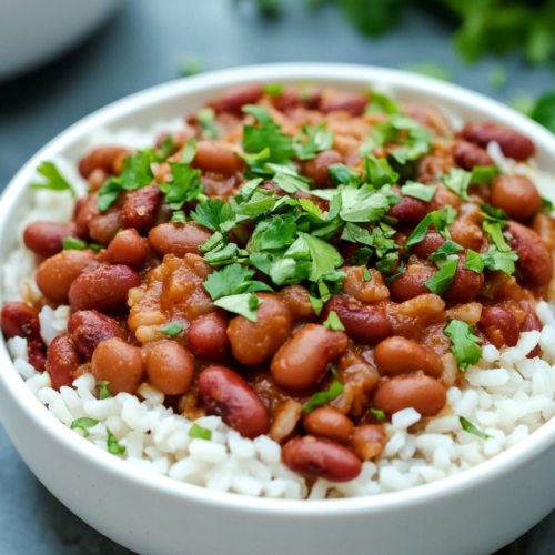 Homemade beans and rice dish garnished with fresh green herbs