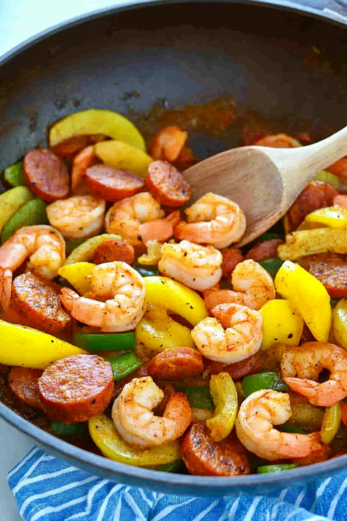Savory skillet combination of seafood, sausage, and vegetables with a golden, flavorful finish.