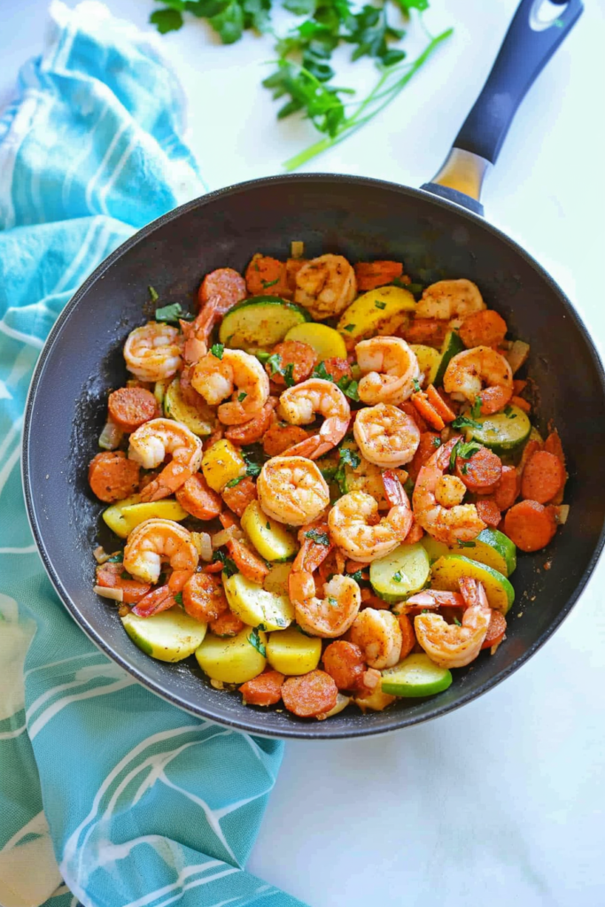 Hearty one-pan dish featuring golden potatoes, browned sausage slices, and tender shrimp.