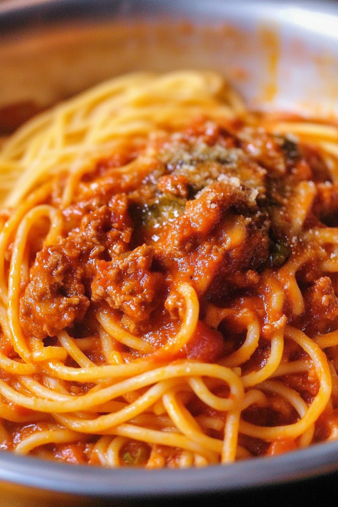 Classic spaghetti dish with glossy tomato-meat sauce and a sprinkle of Parmesan