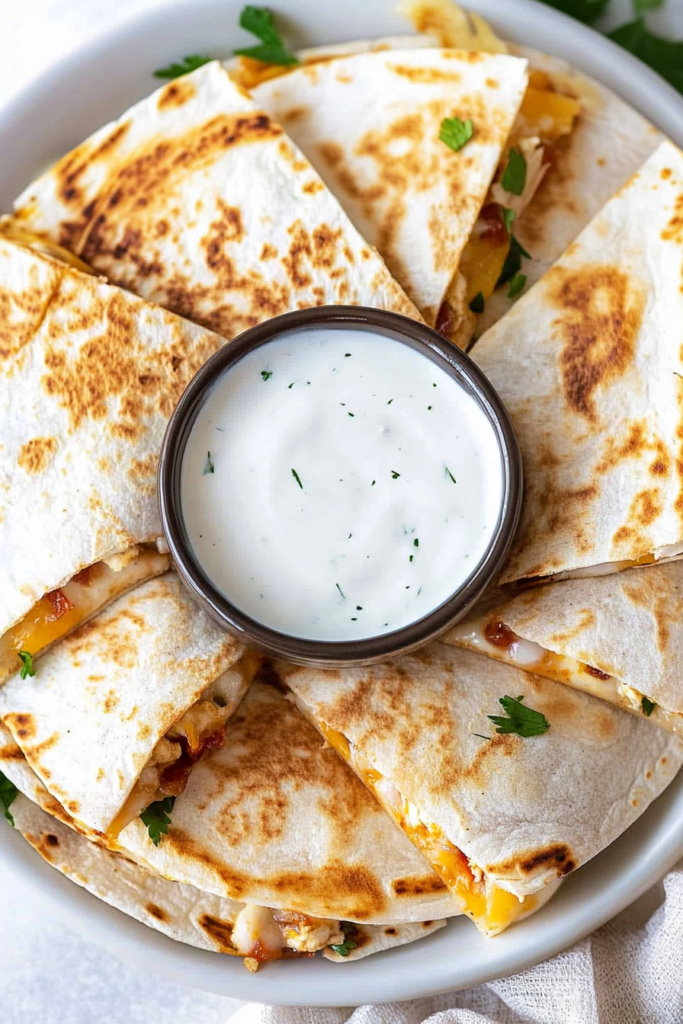 Crispy quesadilla wedges filled with chicken, melted cheese, and bacon pieces