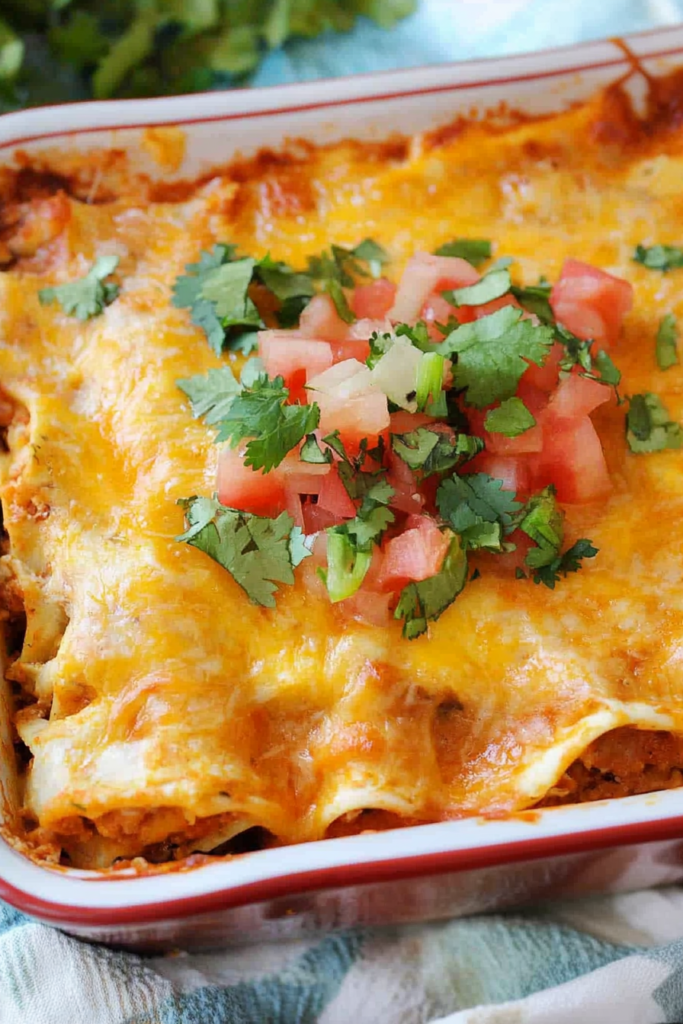 Hearty chicken and tortilla bake with gooey cheese and tomato garnish.