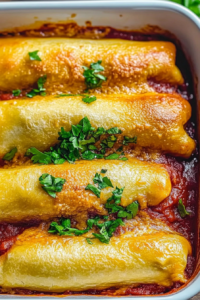 Freshly baked sausage rolls with melted cheddar and parsley sprinkled on top.