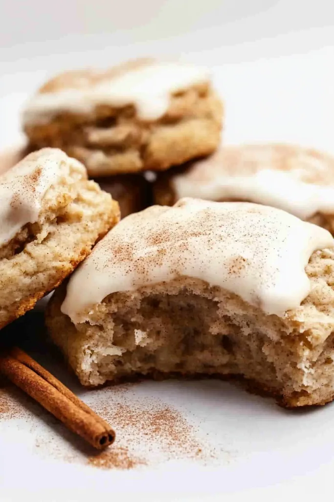 Warm spiced biscuit highlighting its golden surface and creamy icing drizzle.