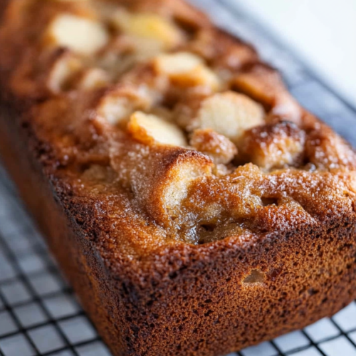 Close-up of a rustic bread with golden crust and shiny glaze.