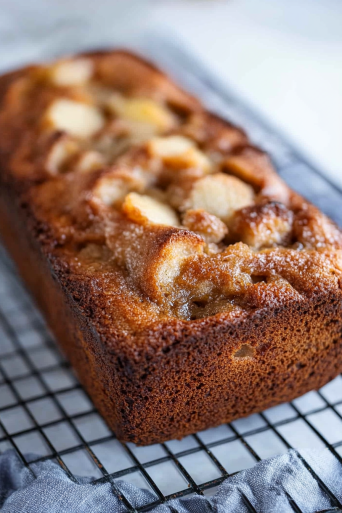 Close-up of a rustic bread with golden crust and shiny glaze.