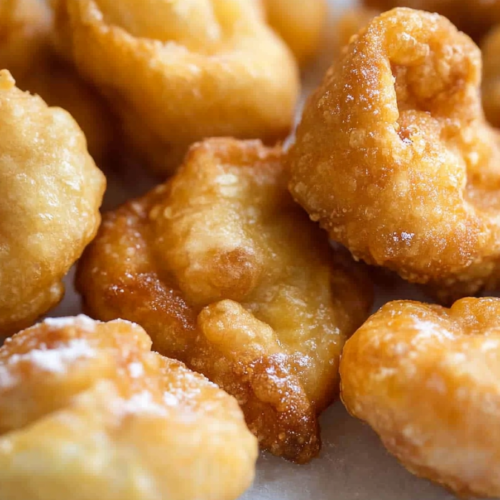 Small deep-fried dough bites with a crisp coating, perfect for dipping in chocolate