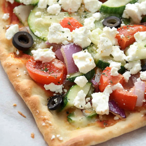 Final plated shot of Greek Veggie Pizza Squares, showcasing thick crust and vibrant vegetables