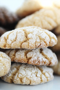 Freshly baked cookies stacked on a tray, highlighting their tender texture and holiday feel.