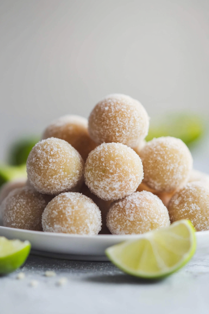 Sparkling citrus-inspired sweets arranged neatly, with lime slices adding a fresh touch.