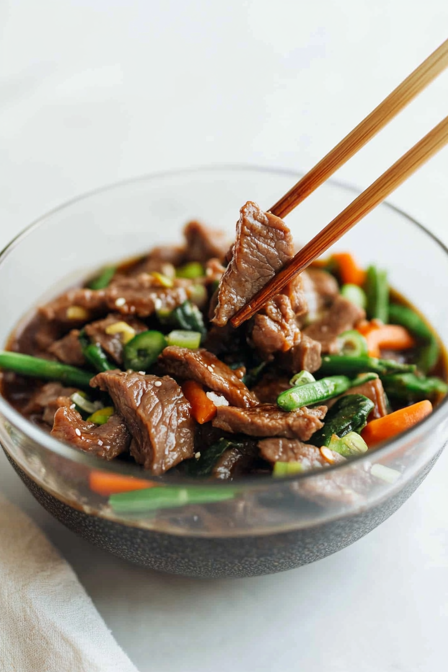 Juicy sliced beef coated in rich brown sauce with carrots and green beans.