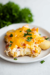 Comfort food presentation with potatoes smothered in gooey cheese and smoky bacon.