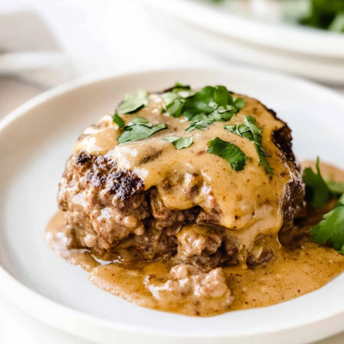 Homemade beef steak with creamy brown gravy served warm and ready to eat.
