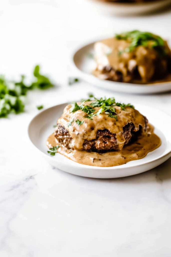 Juicy beef patty covered in rich onion mushroom gravy and garnished with fresh parsley.