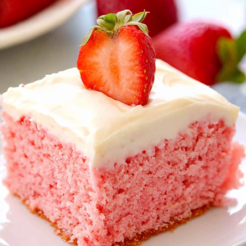 Final plated portion of strawberries and cream cake highlighting its fluffy texture and vibrant colors.
