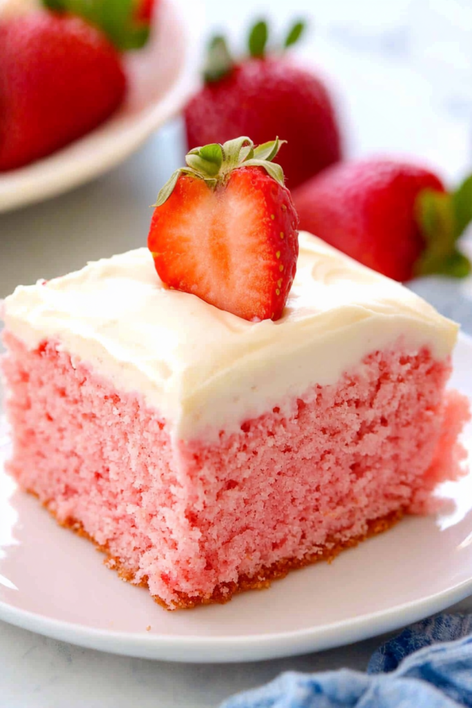Final plated portion of strawberries and cream cake highlighting its fluffy texture and vibrant colors.