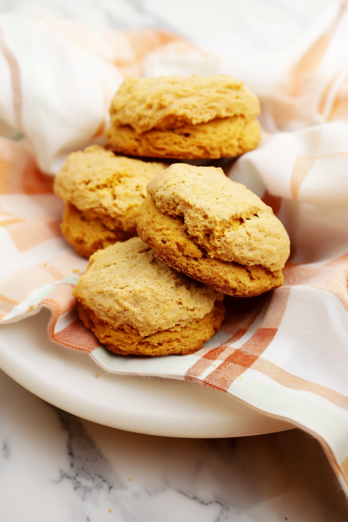 Biscuits arranged neatly, golden-brown surface glowing under natural kitchen light.