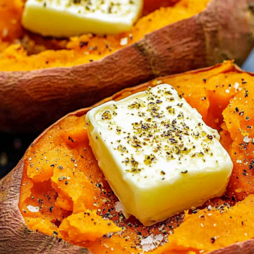 Warm sweet potato halves seasoned with salt, pepper, and butter