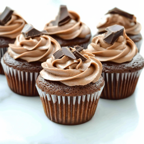 Moist cupcake with rich chocolate frosting and sprinkled chocolate pieces