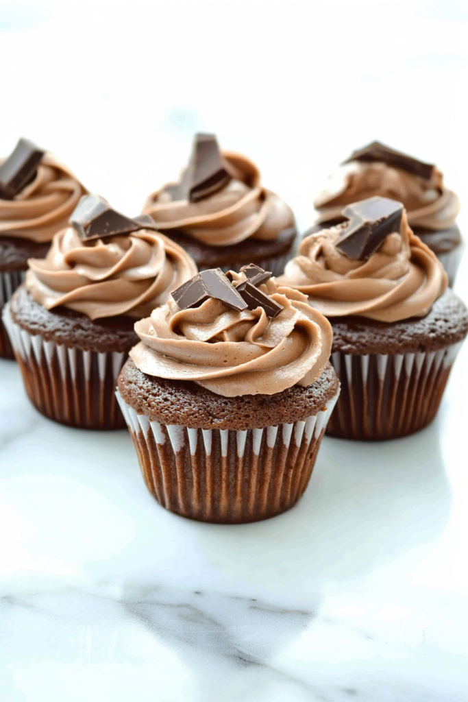 Moist cupcake with rich chocolate frosting and sprinkled chocolate pieces