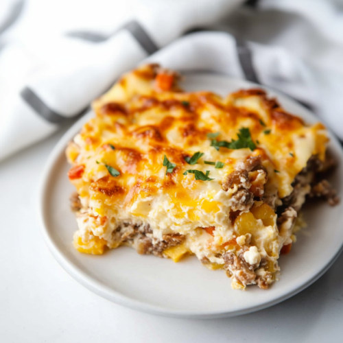 Final shot of casserole slice highlighting pasta layers, meat filling, and melted cheese crust.
