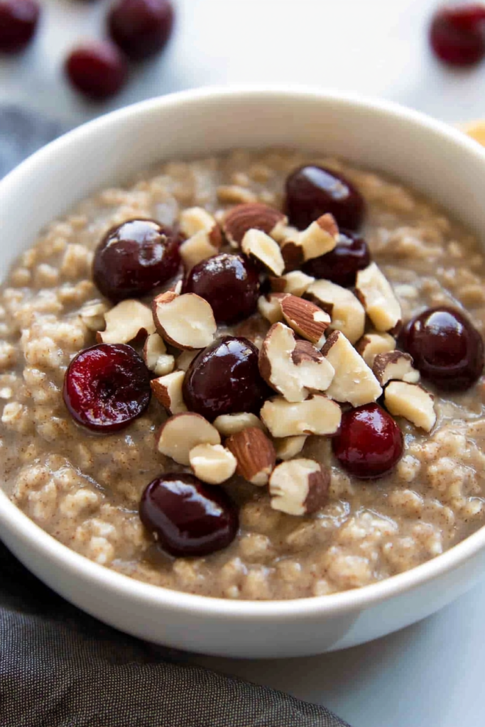 Comforting breakfast dish with creamy oats, fresh cherries, and nutty crunch.