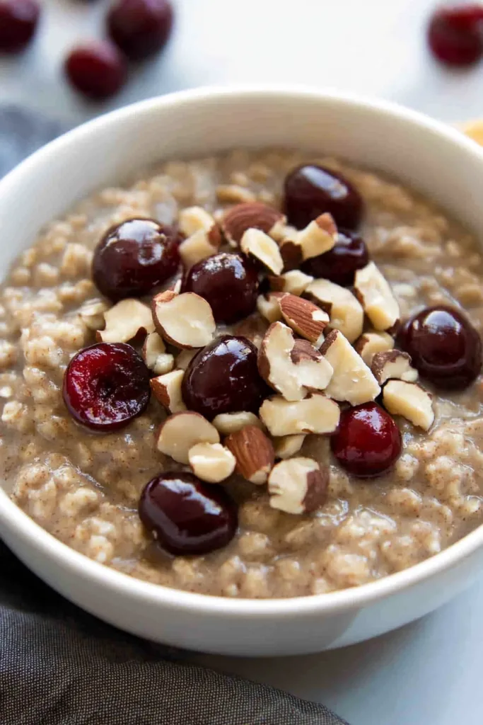 Comforting breakfast dish with creamy oats, fresh cherries, and nutty crunch.