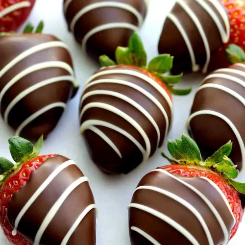 Overhead view of strawberries showcasing their vibrant color against smooth chocolate layers.