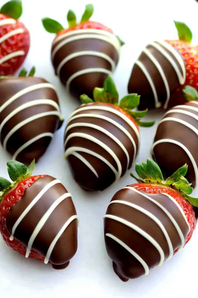 Overhead view of strawberries showcasing their vibrant color against smooth chocolate layers.