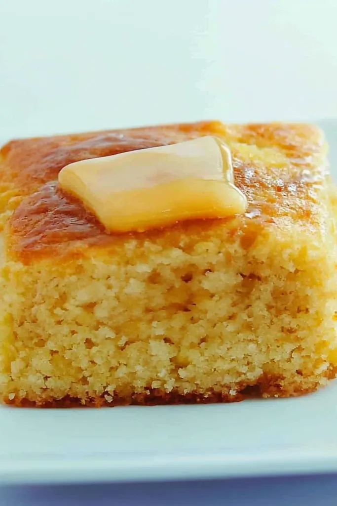 Warm slice of cornbread highlighting its golden crust and soft interior.