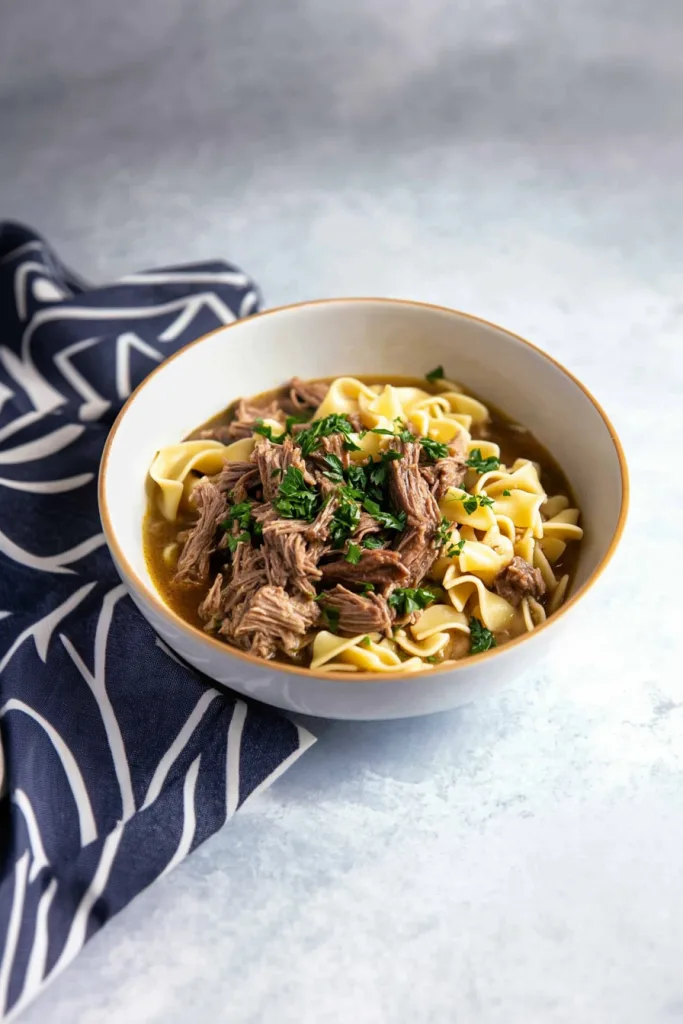 Tender shredded beef served over buttery egg noodles in a rich homemade broth