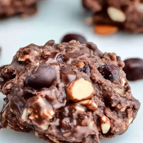 Plate of rustic chocolate crisps, highlighting their chunky surface.