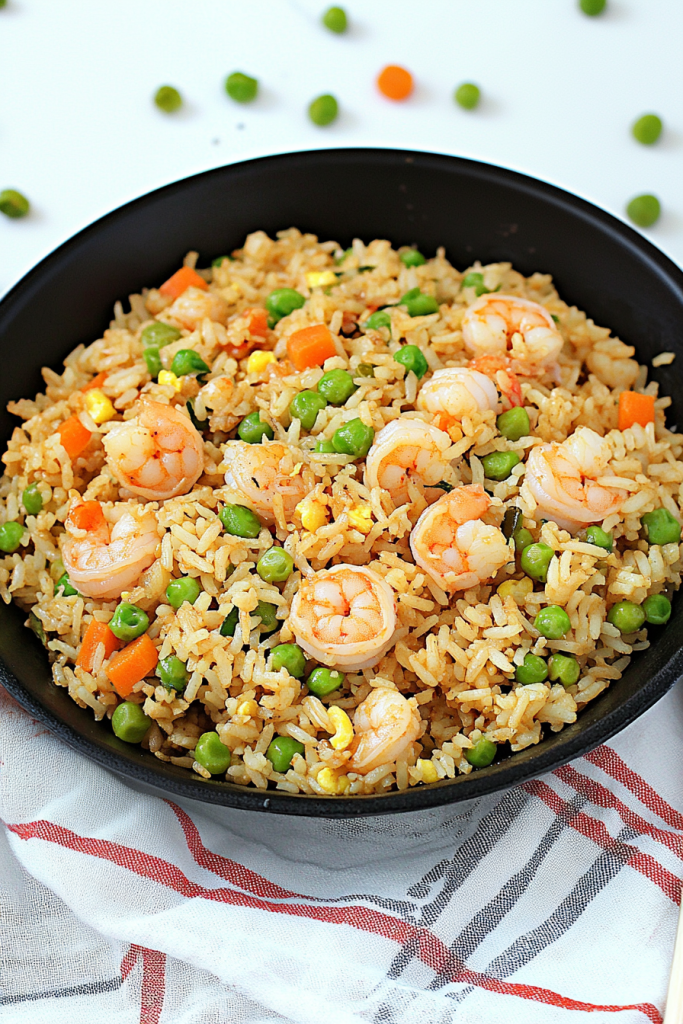 Fluffy rice stir-fried with plump shrimp and colorful vegetables, ready to serve