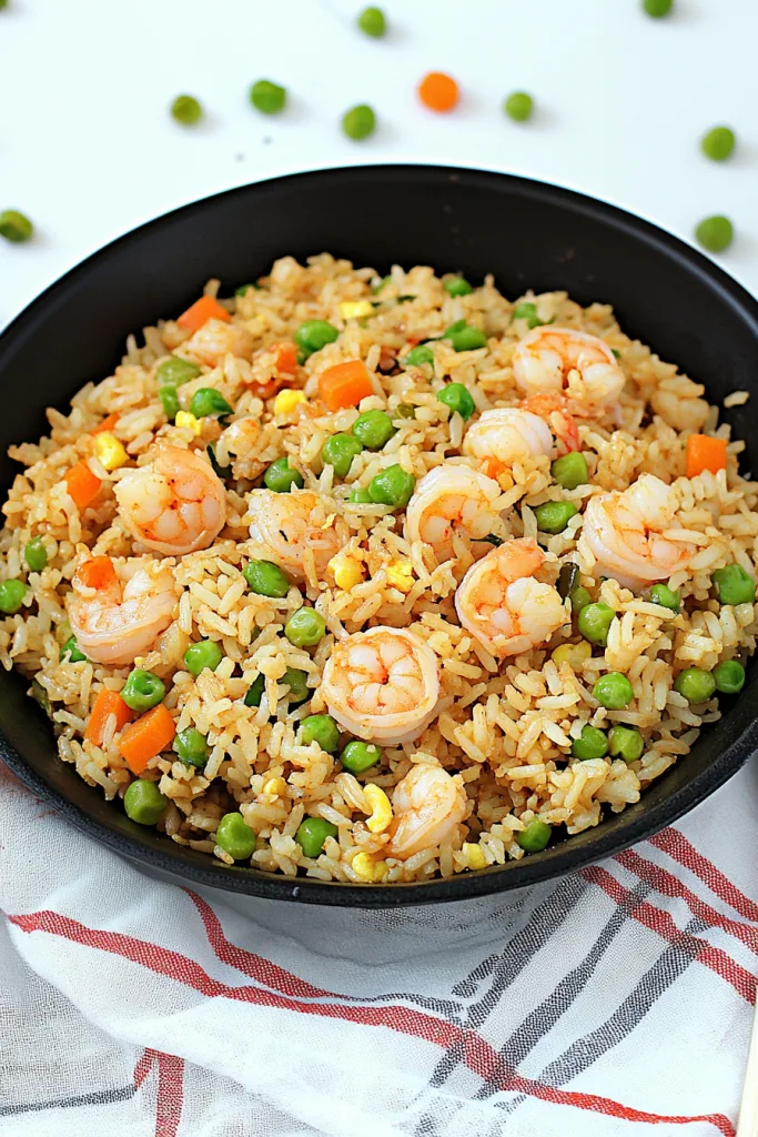 Fluffy rice stir-fried with plump shrimp and colorful vegetables, ready to serve